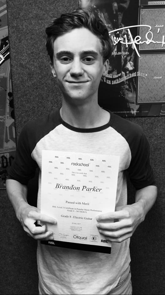 Brandon with his Grade 8 electric guitar certificate