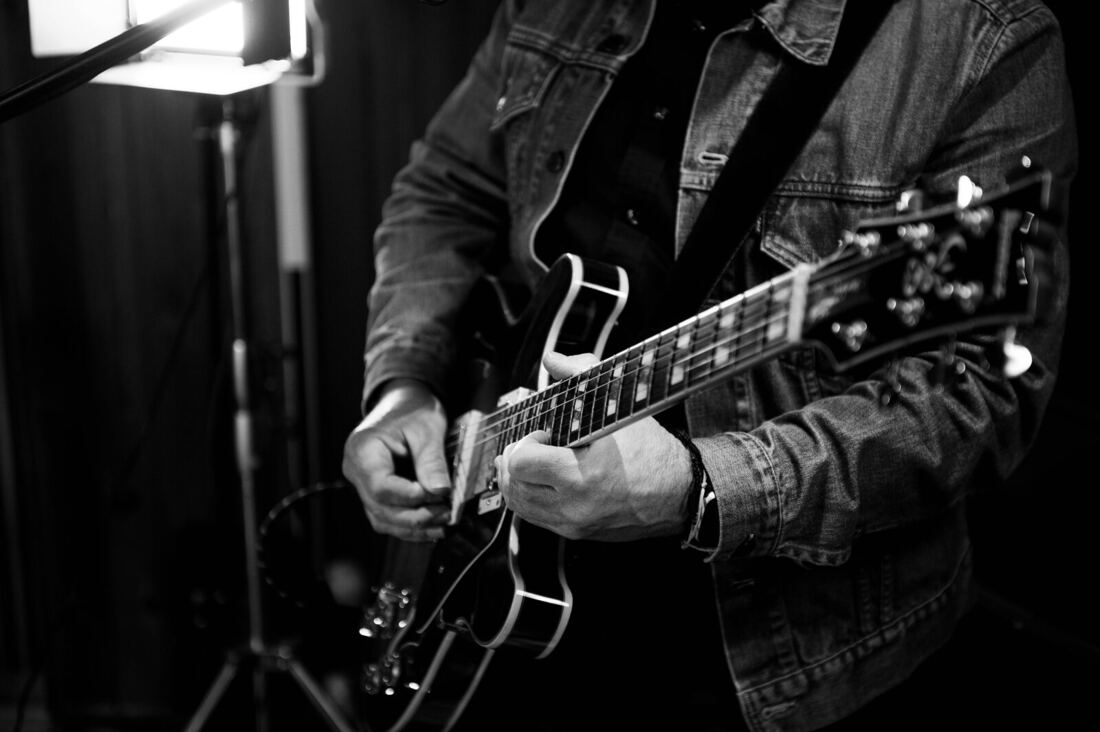 Close-up of Dan playing guitar